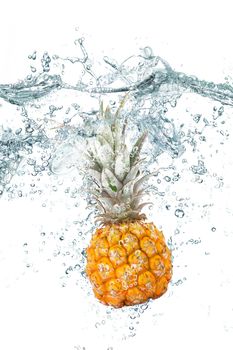 fresh pineapple falling in water