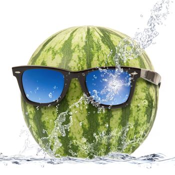 fresh watermelon falling in water