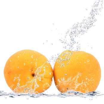 fresh apricots falling in water