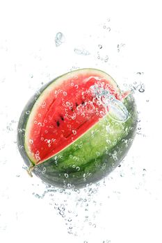 fresh watermelon falling in water