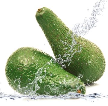 fresh avocado falling in water
