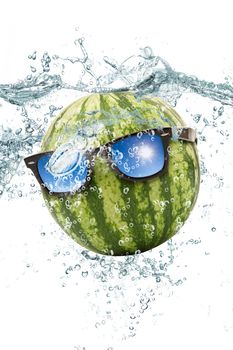 fresh watermelon falling in water