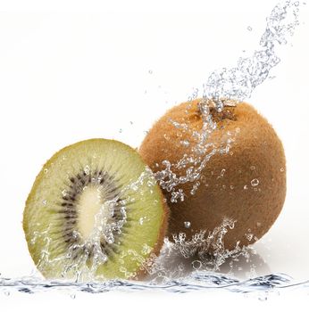 fresh kiwi falling in water