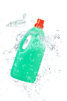 green plastic bottle falling in water