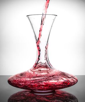 decanter with wine flowing within