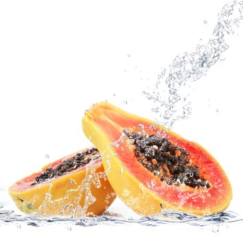 fresh papaya falling in water