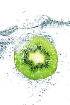 fresh kiwi falling in water