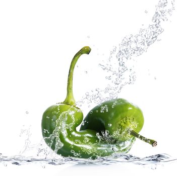 fresh peppers falling in pure water