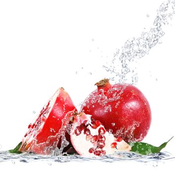 fresh pomegranate falling in water