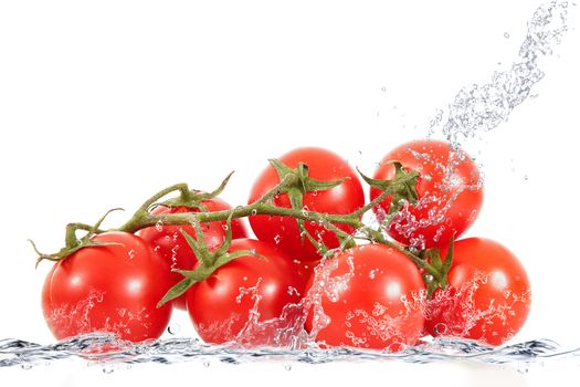 fresh tomatoes falling in pure water