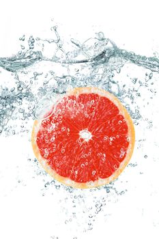 fresh grapefruit falling in water