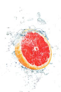 fresh grapefruit falling in water