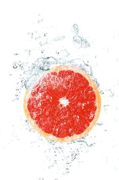 fresh grapefruit falling in water