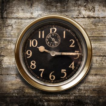 a vintage watch on a wooden background