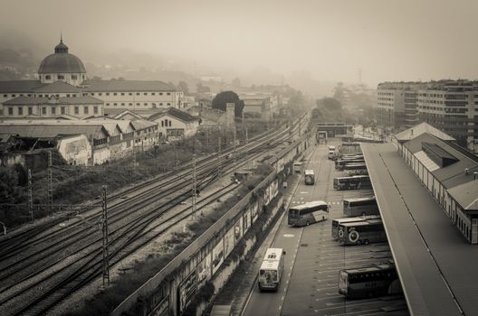 Some buses at the bus station and the train tracks carry the viewer to the old better times in Oviedo, Asturias, Spain