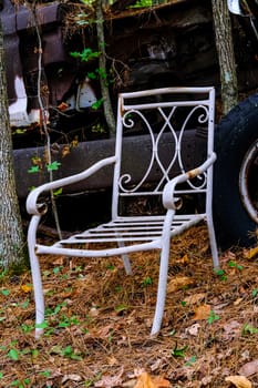 Old White Metal Chair in a Junkyard
