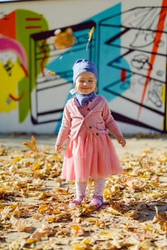 Adorable girl having fun on beautiful autumn day. Authentic picture.