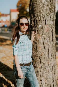 Autumn attractive woman portrait smiling outdoors at the park. Authentic and natural photographs