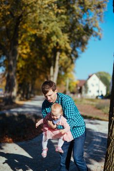 Happy loving family. Father and his daughter child girl playing and hugging outdoors. Authentic lifestyle. Concept of Father's day.