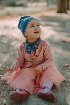 Adorable girl having fun on beautiful autumn day. Authentic picture.