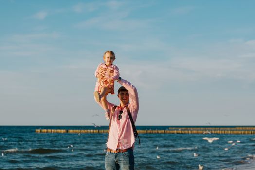 Happy loving family. Father and his daughter child girl playing and hugging outdoors. Authentic lifestyle. Concept of Father's day.