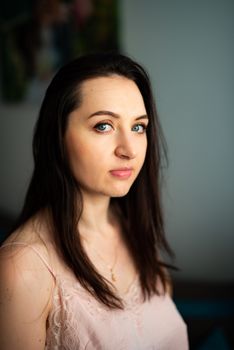 Portrait of a young gorgeous brunette in sexy gown. Focus on her face.