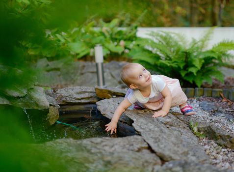 Smiling girl in the park in summer time. Authentic lifestyle image
