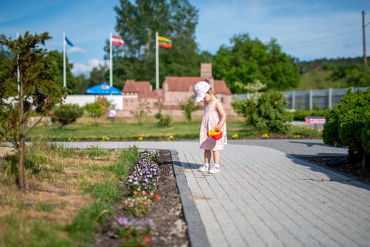 Little girl spending fantastic time on playground. Happy childhood. Authentic image