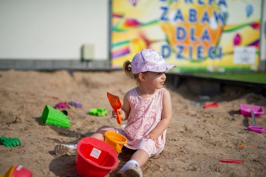 Little girl spending fantastic time on playground. Happy childhood.