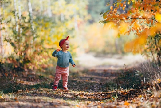 Adorable girl having fun on beautiful autumn day. Authentic picture.