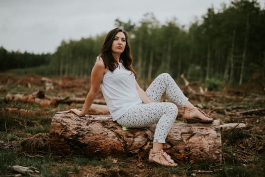 Woman in the forest where the purple heather blooms. copy space. Authentic lifestyle image