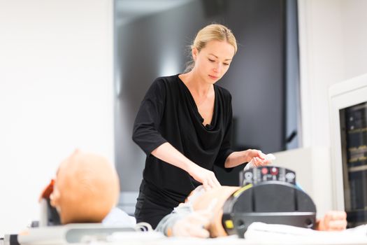 Medical doctor specialist expert displaying method of patient intubation technique on hands on medical education training and workshop.