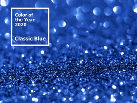 Sparkling background with bokeh made of Classic Blue 2020 color. Color of year 2020 blurred backdrop for holidays and parties. COY2020 Classic Blue concept. Copy space for text