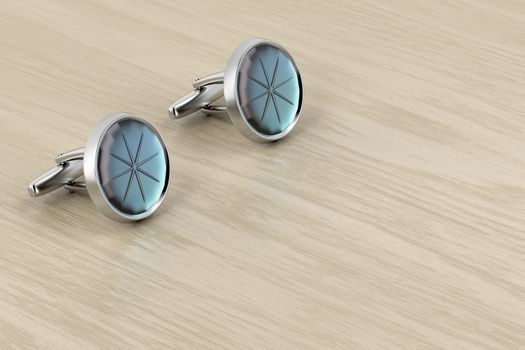 Silver cufflinks on wood table