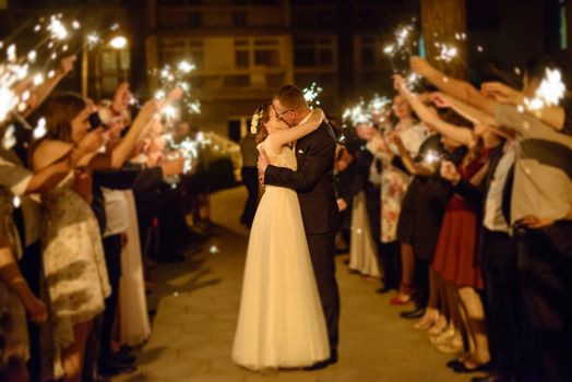 Bride and groom dancing the first dance at their wedding day. Guest on the dancefloor
