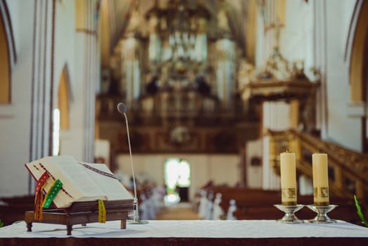 Church sanctuary before a wedding ceremony. Empty chairs for bride and groom