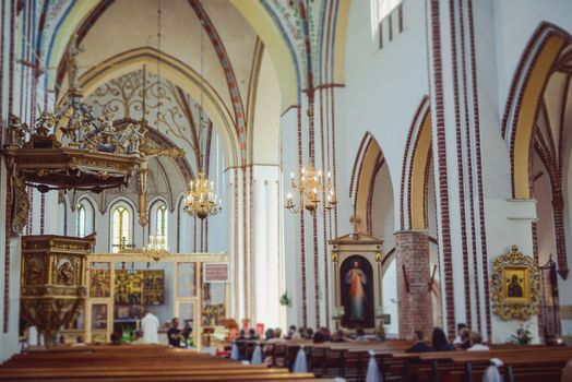 Church sanctuary before a wedding ceremony. Empty chairs for bride and groom