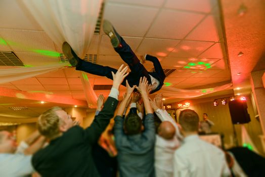 Bride and groom dancing the first dance at their wedding day. Guest on the dancefloor