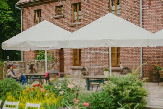 Wedding reception in the open air. Decorated chairs, flowers, candles