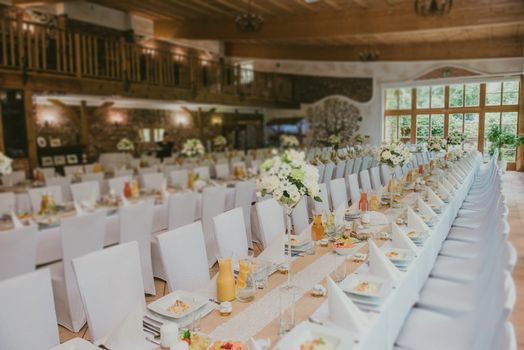 Beautifully decorated wedding table and other details at wedding hall. Wedding day