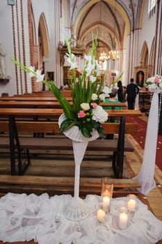 Church sanctuary before a wedding ceremony. Empty chairs for bride and groom