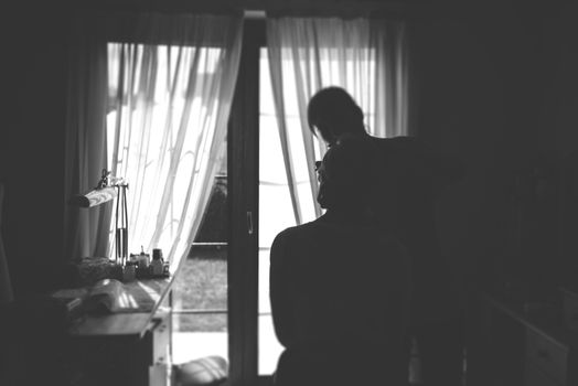Young beautiful bride applying wedding make-up by professional make-up artist.