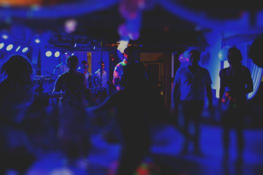 Bride and groom dancing the first dance at their wedding day. Guest on the dancefloor