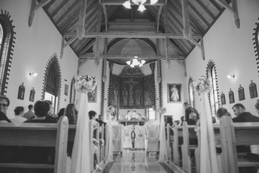 Church sanctuary before a wedding ceremony. Empty chairs for bride and groom