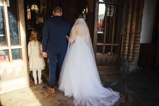 Bride and groom at church wedding during ceremony. Beautiful decoration