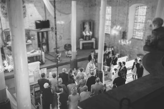 Bride and groom at church wedding during ceremony. Beautiful decoration