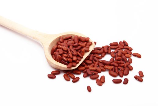 red beans on wooden spoon on white background