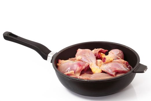 raw chicken in pot on white background