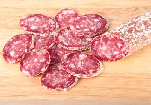 italian salami slices on chopping board background