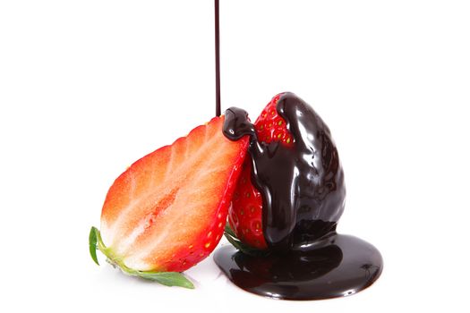 fresh strawberries with chocolate cream on white background